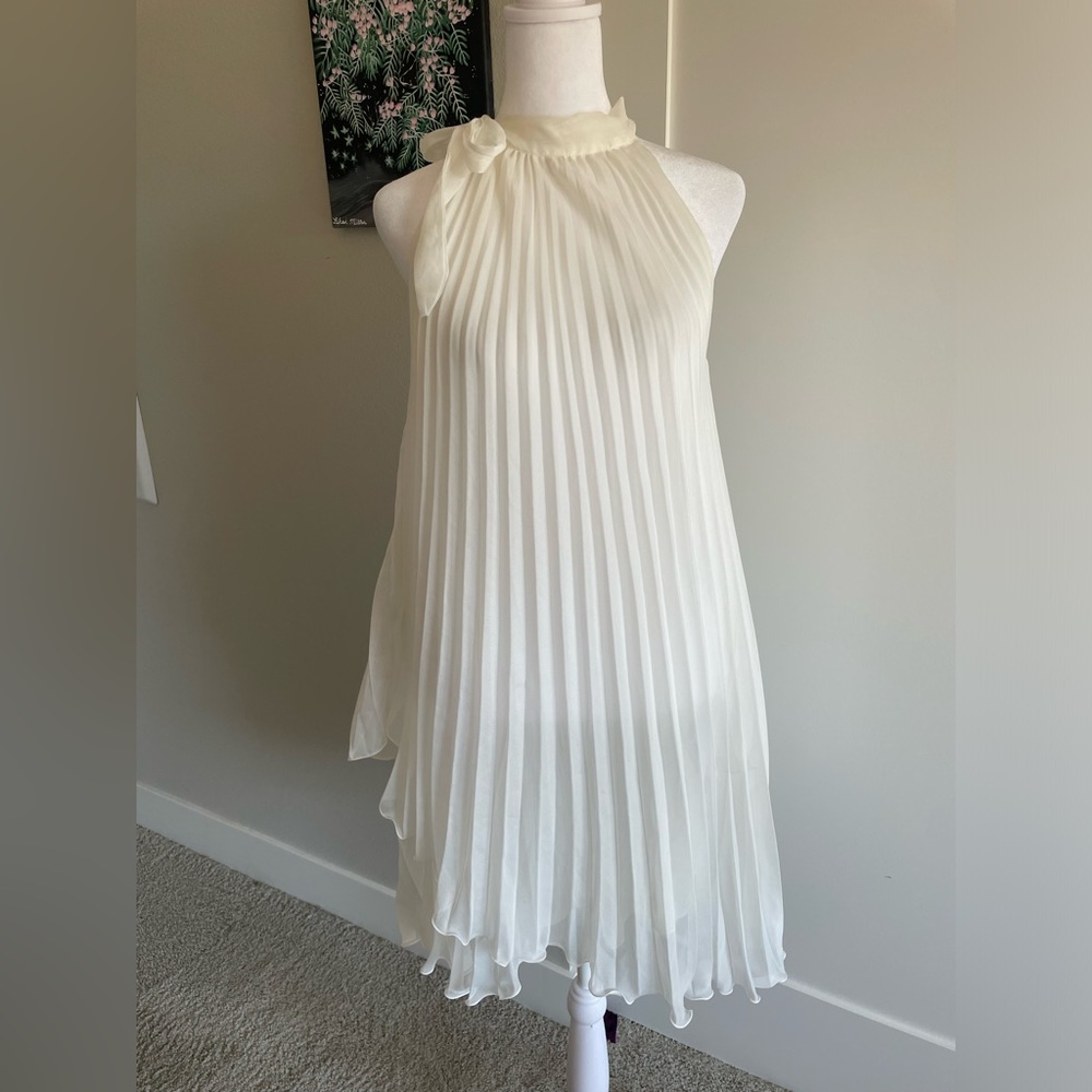 white accordian flouncy high neck line dress